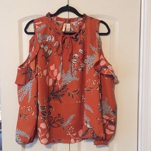 Rust color cold-shoulder floral blouse.